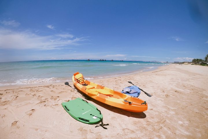 a boat sitting on top of a sandy beach