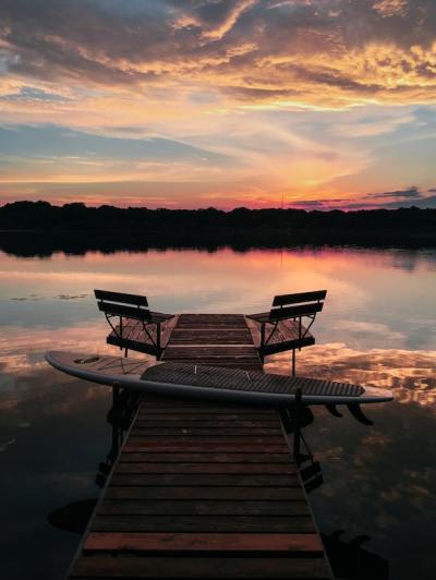 a wooden bench sitting next to a body of water