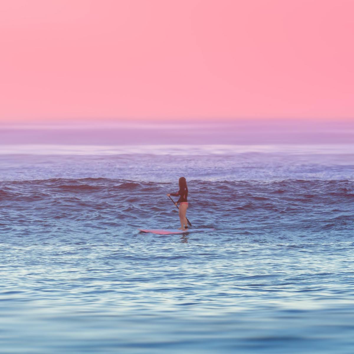 a man standing next to a body of water next to the ocean