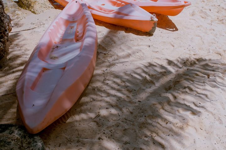 a boat sitting on top of a sandy beach
